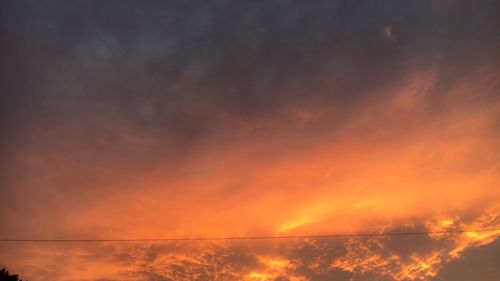 Scenic view of sea against orange sky