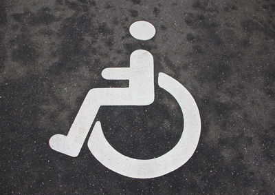 Close-up of disabled sign on road