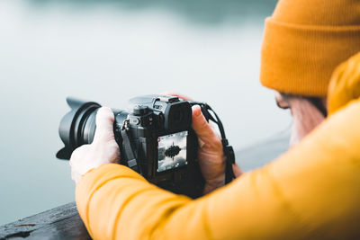 Cropped hand holding camera