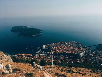 High angle view of sea by cityscape