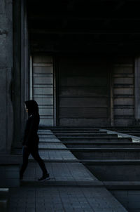 Side view of woman walking in factory