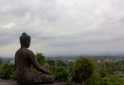 Statue against trees and sky