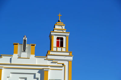 Low angle view of building against clear blue sky