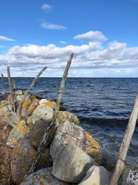 Rocks on beach against sky