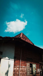 Low angle view of house roof against sky