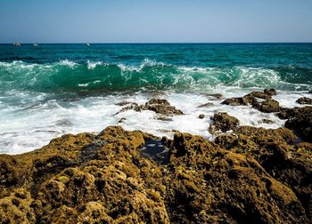 Rock formations by sea against sky