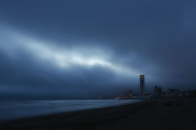 Scenic view of sea against storm clouds at night