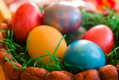 Colourful easter eggs in stone basket