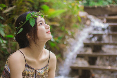 Close-up of beautiful young woman looking away 