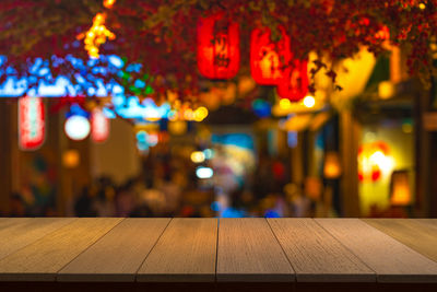 Illuminated lights on table in restaurant at night