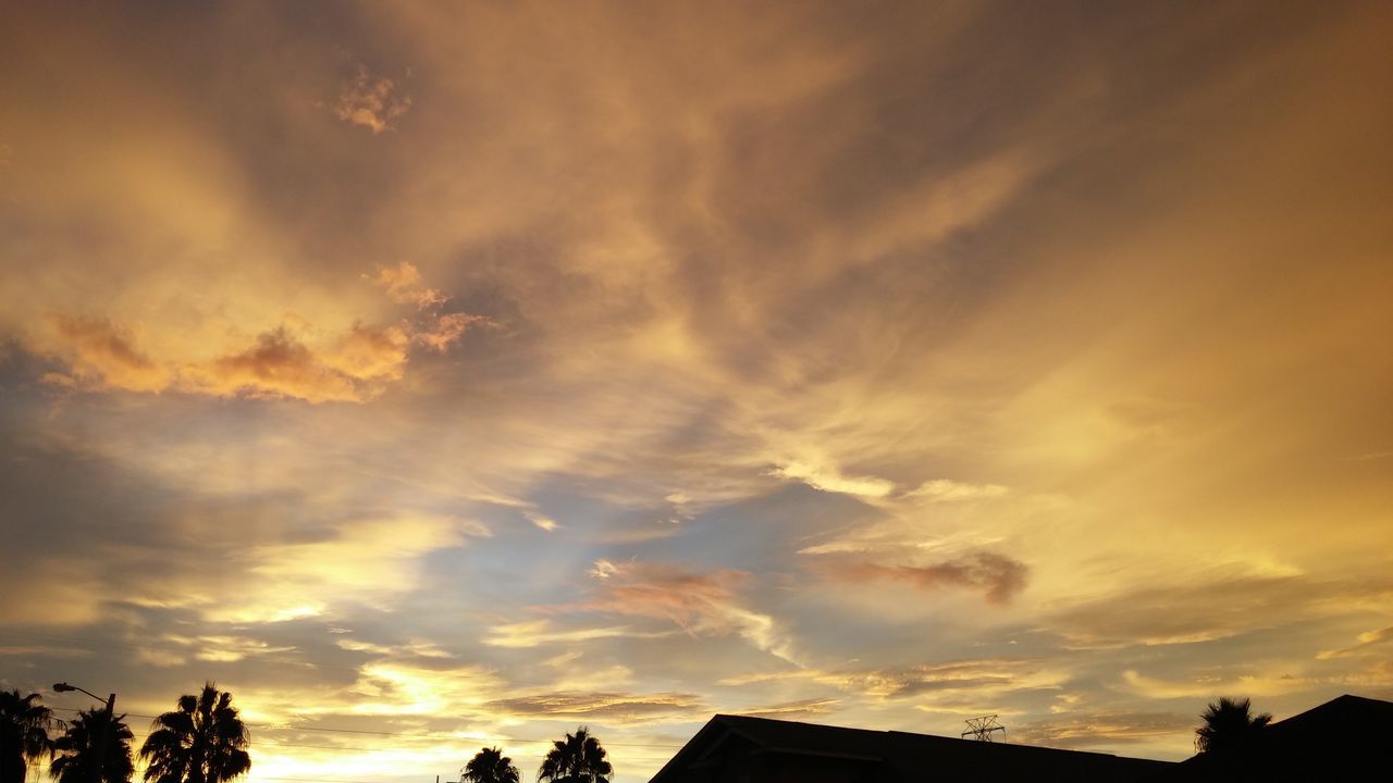 low angle view, sky, sunset, silhouette, cloud - sky, tree, building exterior, built structure, architecture, high section, beauty in nature, orange color, scenics, cloudy, nature, cloud, house, outdoors, dramatic sky, tranquility