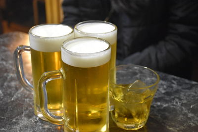 Close-up of beer in glasses on table