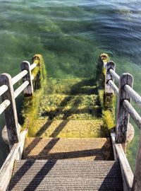 High angle view of railing by sea