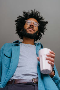 Low angle view of man holding coffee