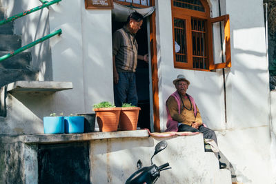 Man working in front of built structure