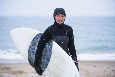 Young woman going winter surfing in snow