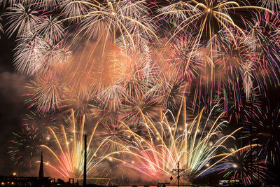 Low angle view of firework display at night