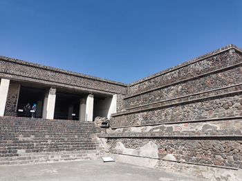 Low angle view of building against clear blue sky