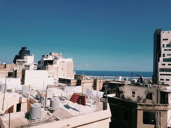 High angle view of buildings against clear blue sky