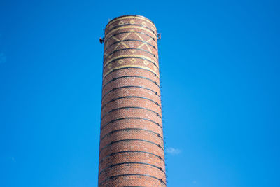 Low angle view of tower against clear blue sky