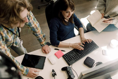 High angle view of computer programmer working in office