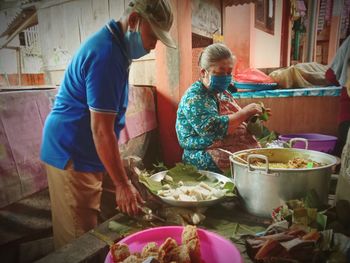 Rear view of people having food