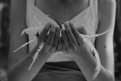 Midsection of woman holding leaf