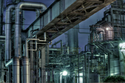 Low angle view of illuminated industry at night