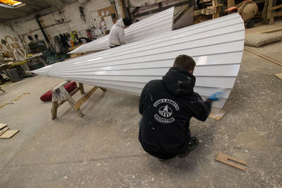 High angle view of man sitting on street