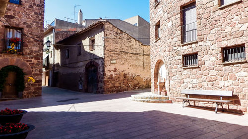 Empty alley amidst buildings in city