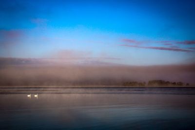Scenic view of sea against sky at sunset