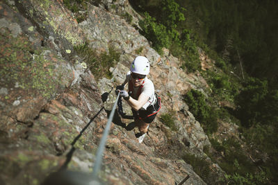 Man mountain climbing with equipment