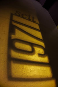 High angle view of text on yellow wall