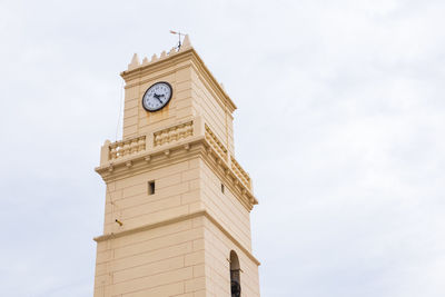 Low angle view of clock tower against sky