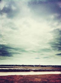 Scenic view of landscape against cloudy sky