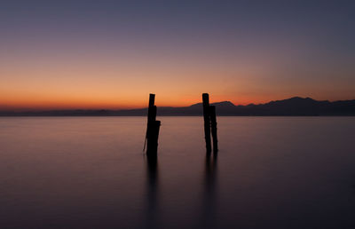 Scenic view of lake against sky during sunset