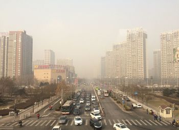 Vehicles on road along buildings