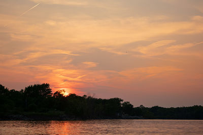 Scenic view of lake against romantic sky at sunset