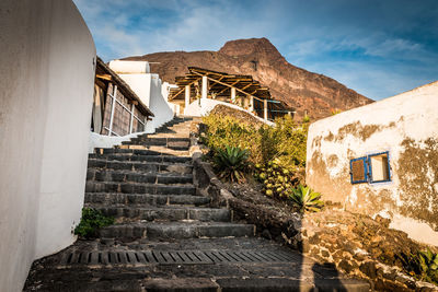 Low angle view of staircase by building against sky