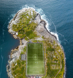 Aeral view of a footballfield on an island