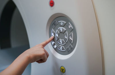 Cropped image of person pressing medical equipment button in hospital 