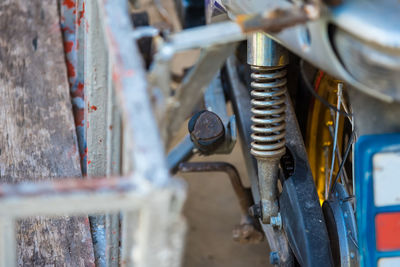 Close-up of old bicycle parked against wall