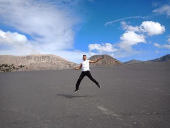 Full length of man on arid landscape against sky