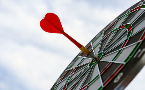 Low angle view of dartboard against sky