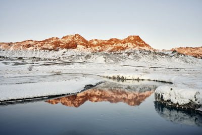 Winter river against mountains with snow