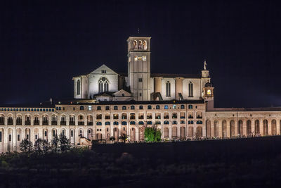 Low angle view of buildings against sky at night