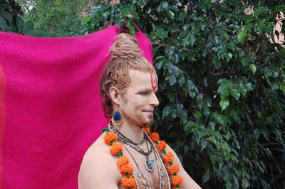 Man with face paint against tree