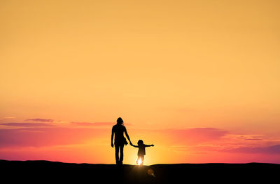 Silhouette of people at sunset