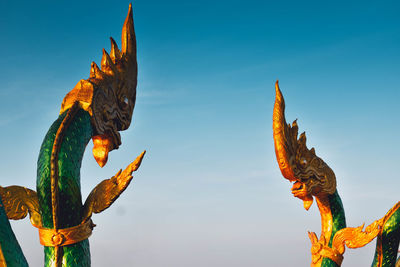 Low angle view of angel statue against sky