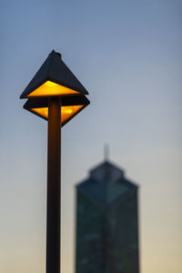 Low angle view of yellow pole against sky during sunset